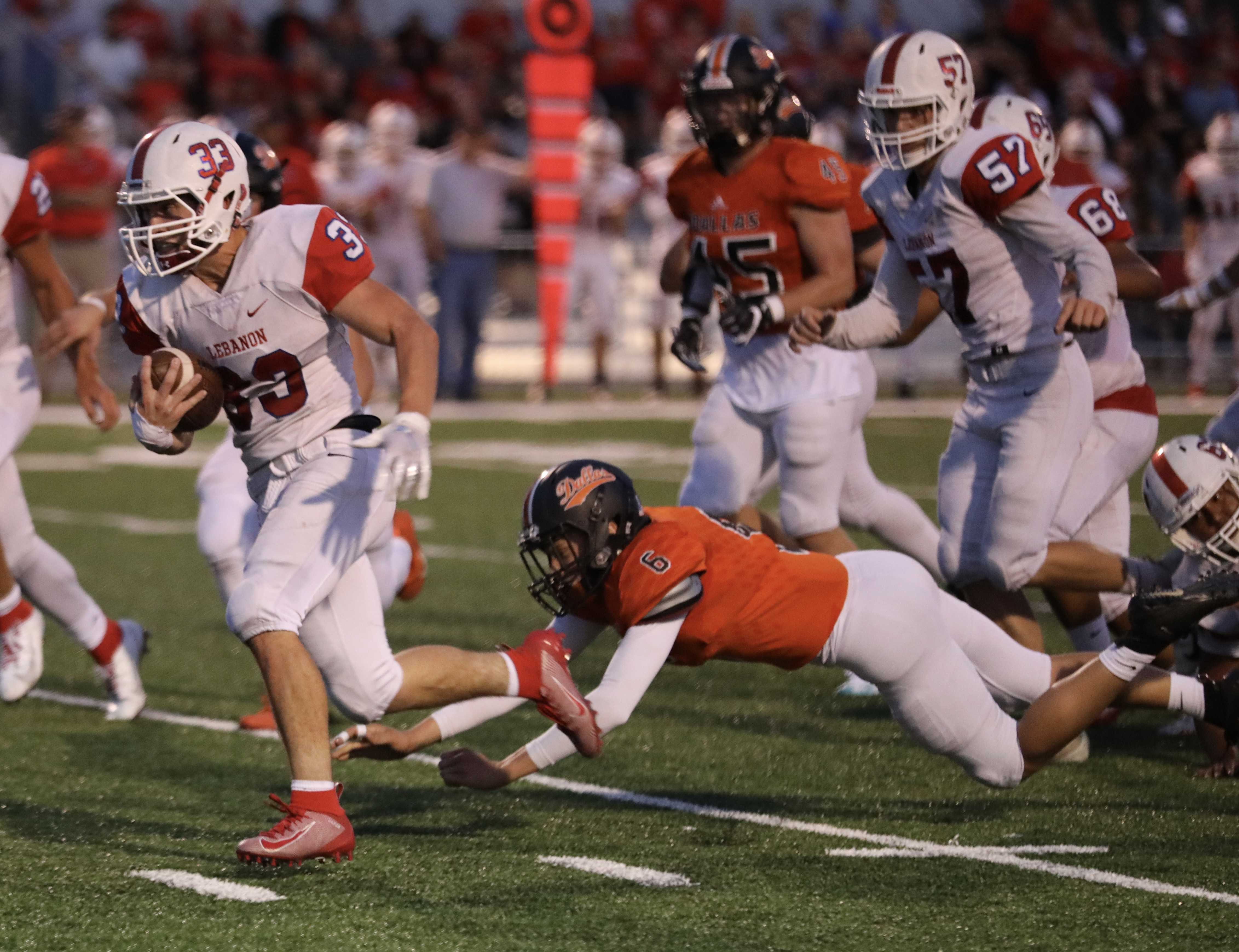 Lebanon running back Brock Barrett escapes the tackle of Dallas' Luke Hess for a 28-yard touchdown run. (Norm Maves Jr.)