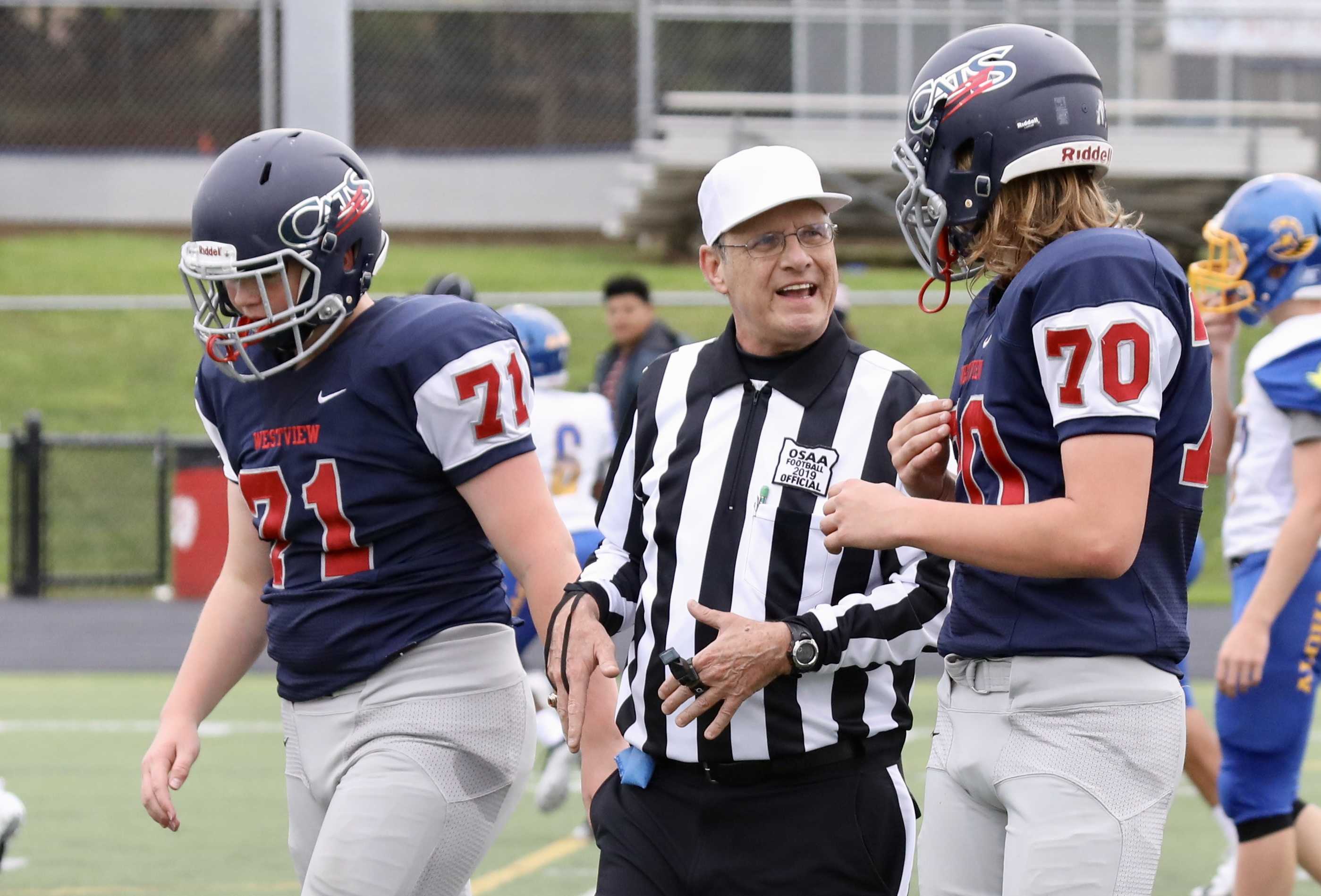 Portland football official Jim Alex explains a procedure to Westview junior varsity tackle Campbell Sager at a recent game.