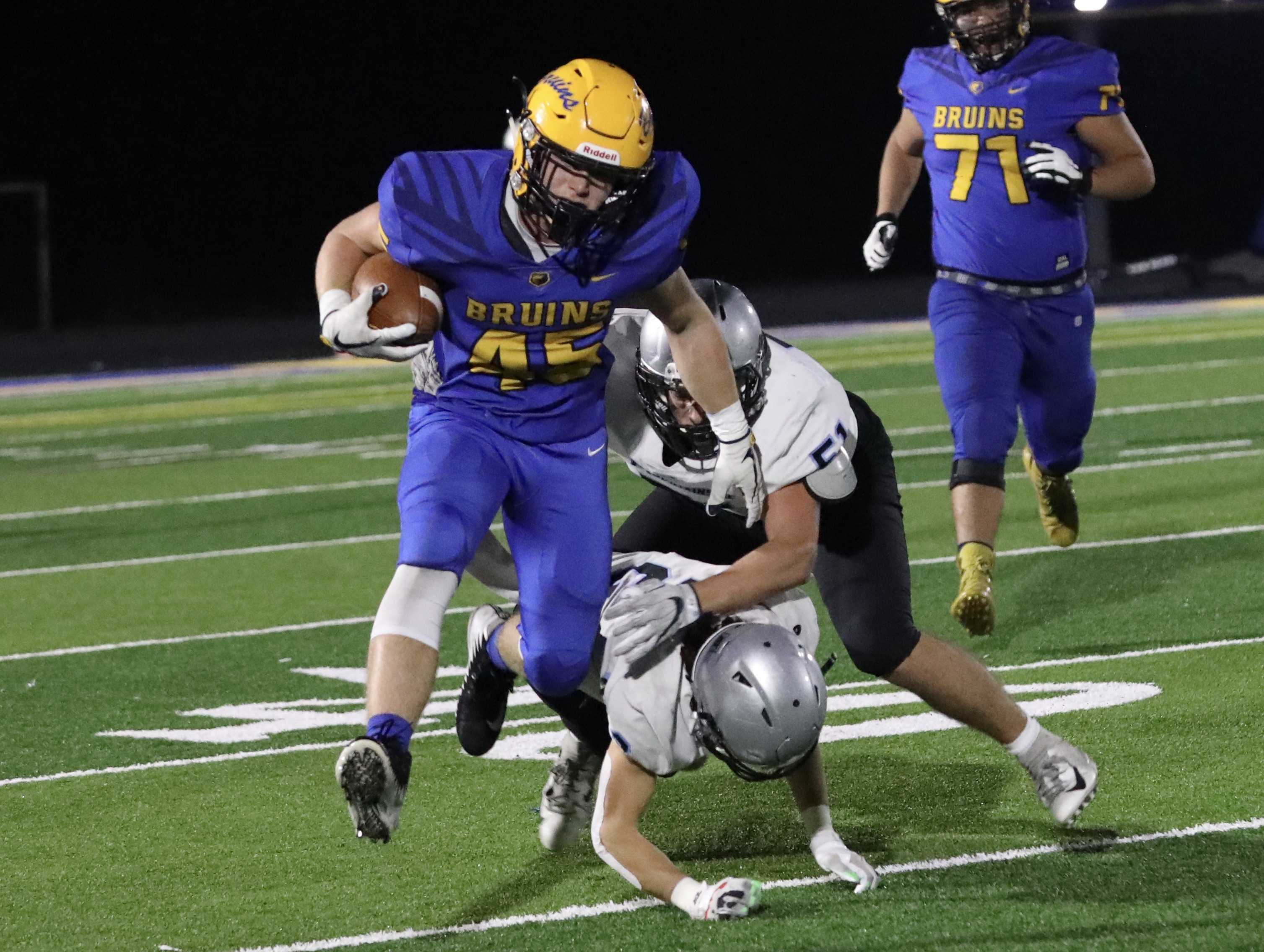 Barlow's Andrew Collins evades two Mountainside tacklers on his way to a 40-yard run on a screen pass. (Norm Maves Jr.)