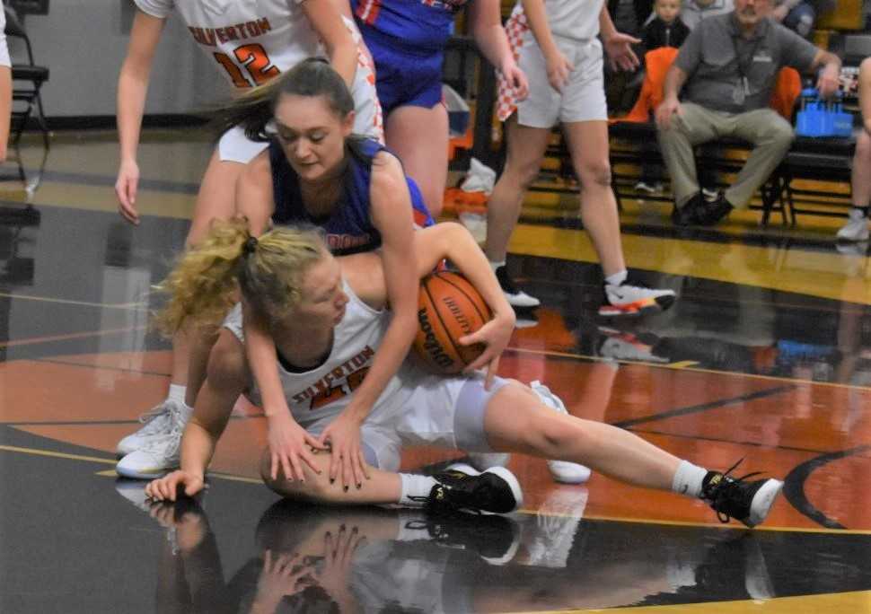 Silverton's Ellie Schmitz (white) goes on the floor for a loose ball Tuesday against Lebanon. (Photo by Jeremy McDonald)