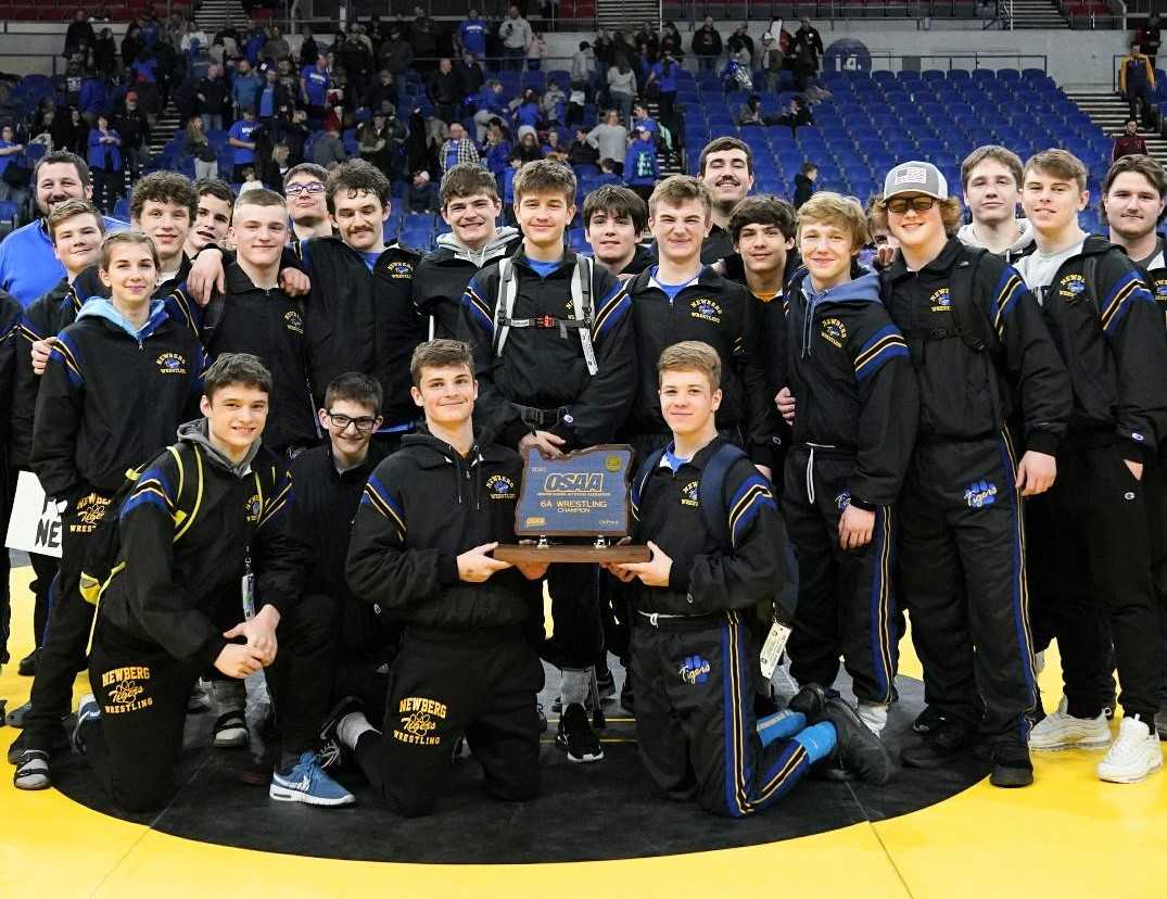 Newberg wrestlers pose with their first championship trophy since 2009. (Photo by Jon Olson)