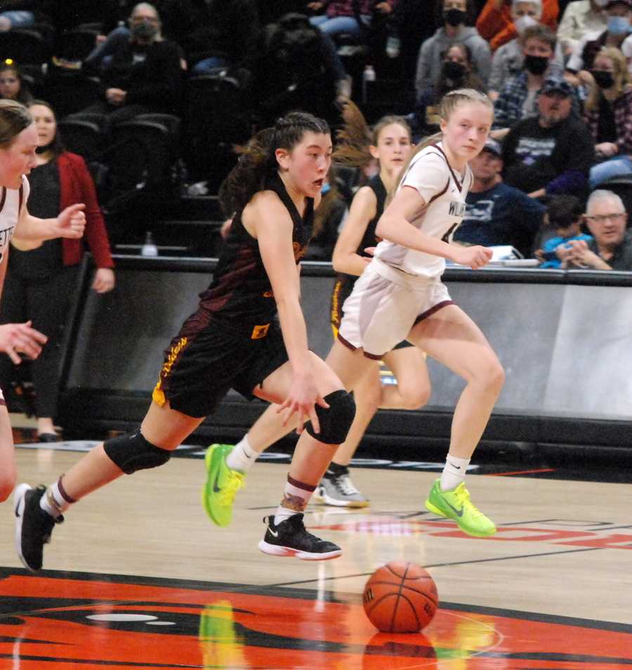 Nicole Huang (with ball) races upcourt for Crescent Valley as Willamette's Maddy Warberg works to keep up. CV won in a thriller