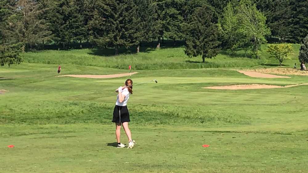 Wells senior Helen Brodahl stares down her tee shot at the par three fifth hole. Brodahl shot 71 to lead the 6A competition by 4