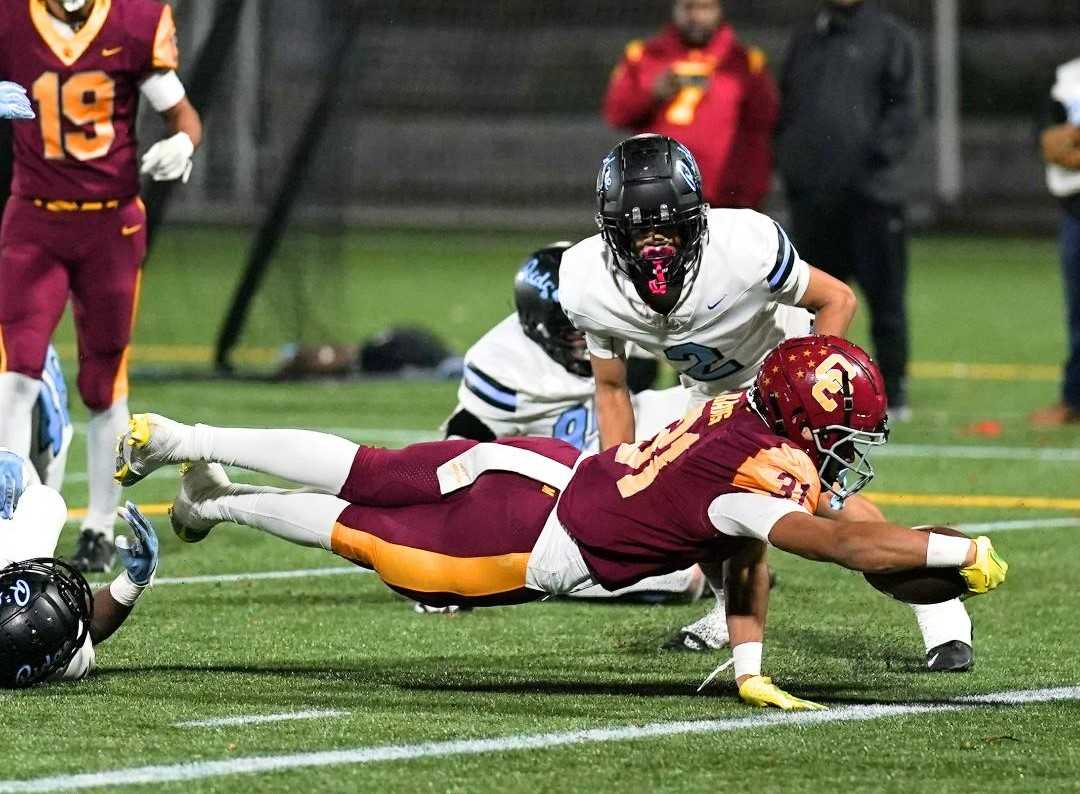 Central Catholic's Tyson Davis dives for a touchdown run in the third quarter of Friday's quarterfinal win. (Photo by Jon Olson)