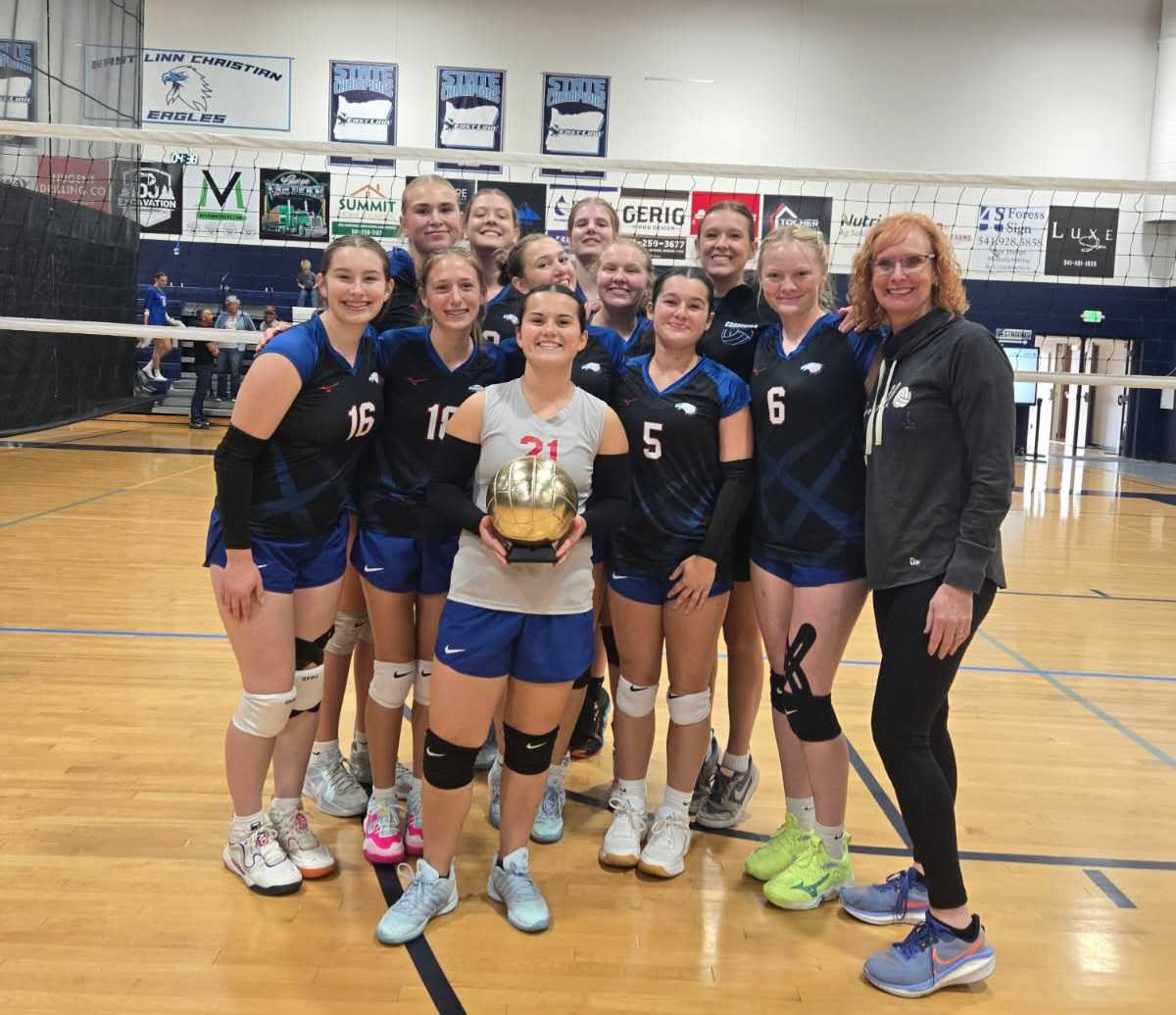 The Crosshill Christian volleyball team poses with a trophy at East Linn Christian High School. (Courtesy photo: Julie Bennett)