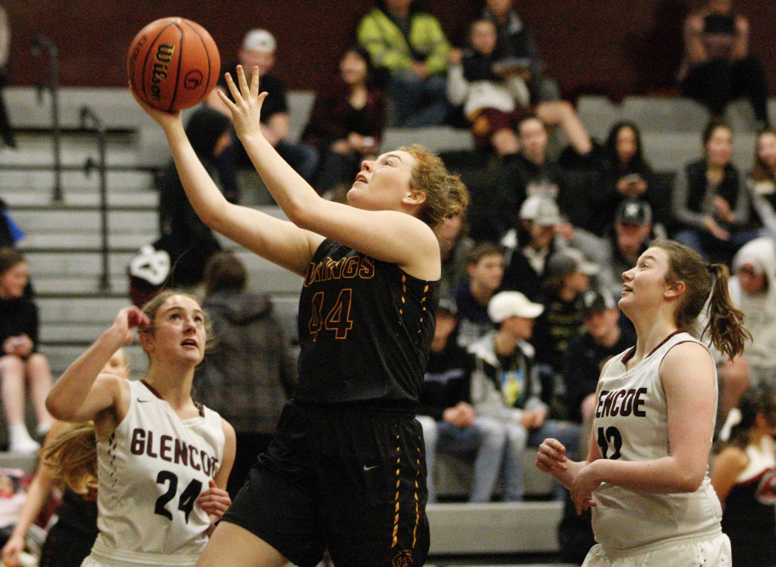 Forest Grove's Olivia Grosse gets between Breauna Van Dyke and Briana Ball of Glencoe for two of her nine points.