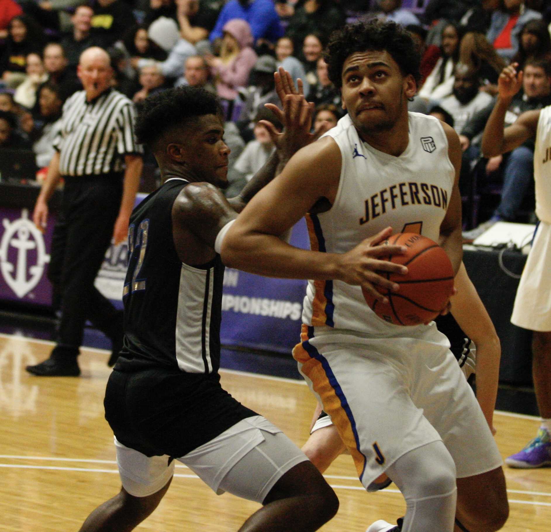 Jefferson's Nate Rawlins-Kibonge powers through Grant's Ty Rankin on his way to the basket. (Norm Maves Jr.)