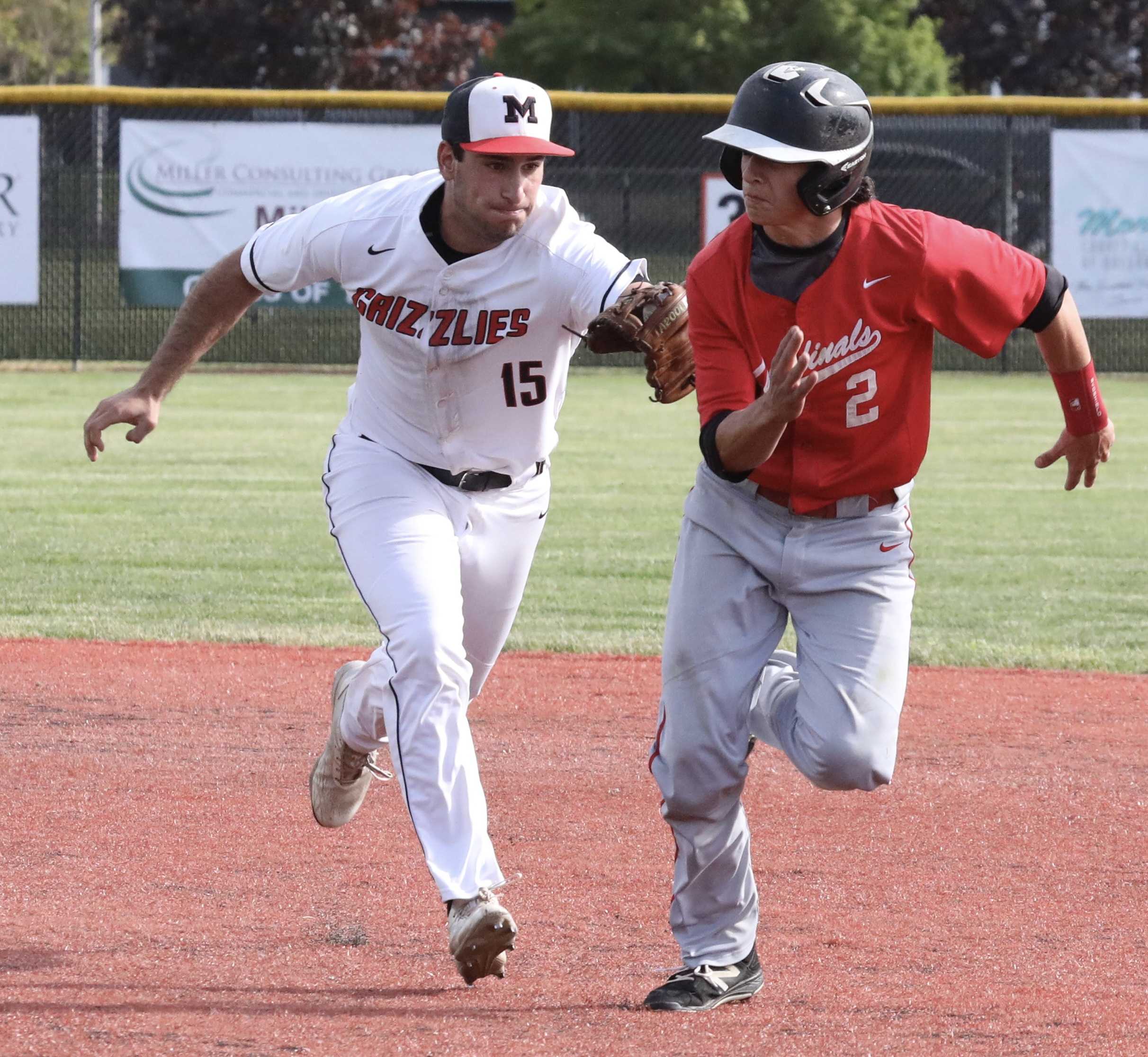 McMinnville second baseman Sam DuPuis tags out Lincoln's Kyle Gragnola on a successful pickoff play in the second inning.