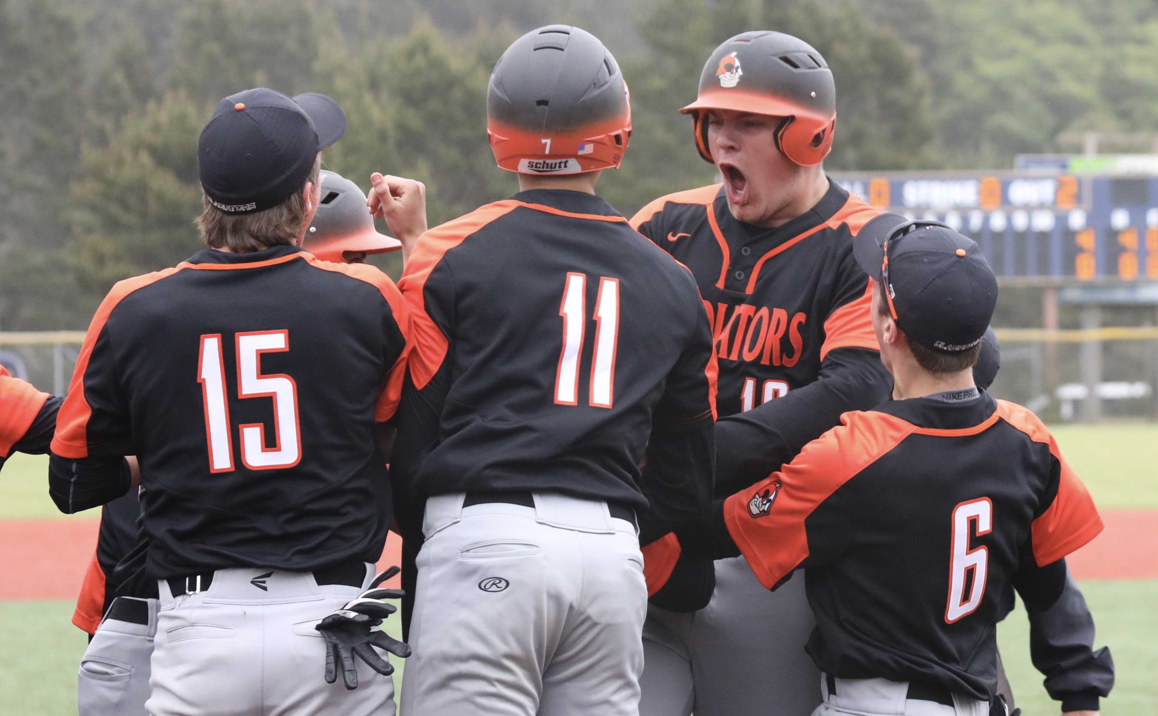 Gladstone's Jackson Simmons, facing camera, celebrates his first-inning home run with his teammates (Norm Maves Jr.)