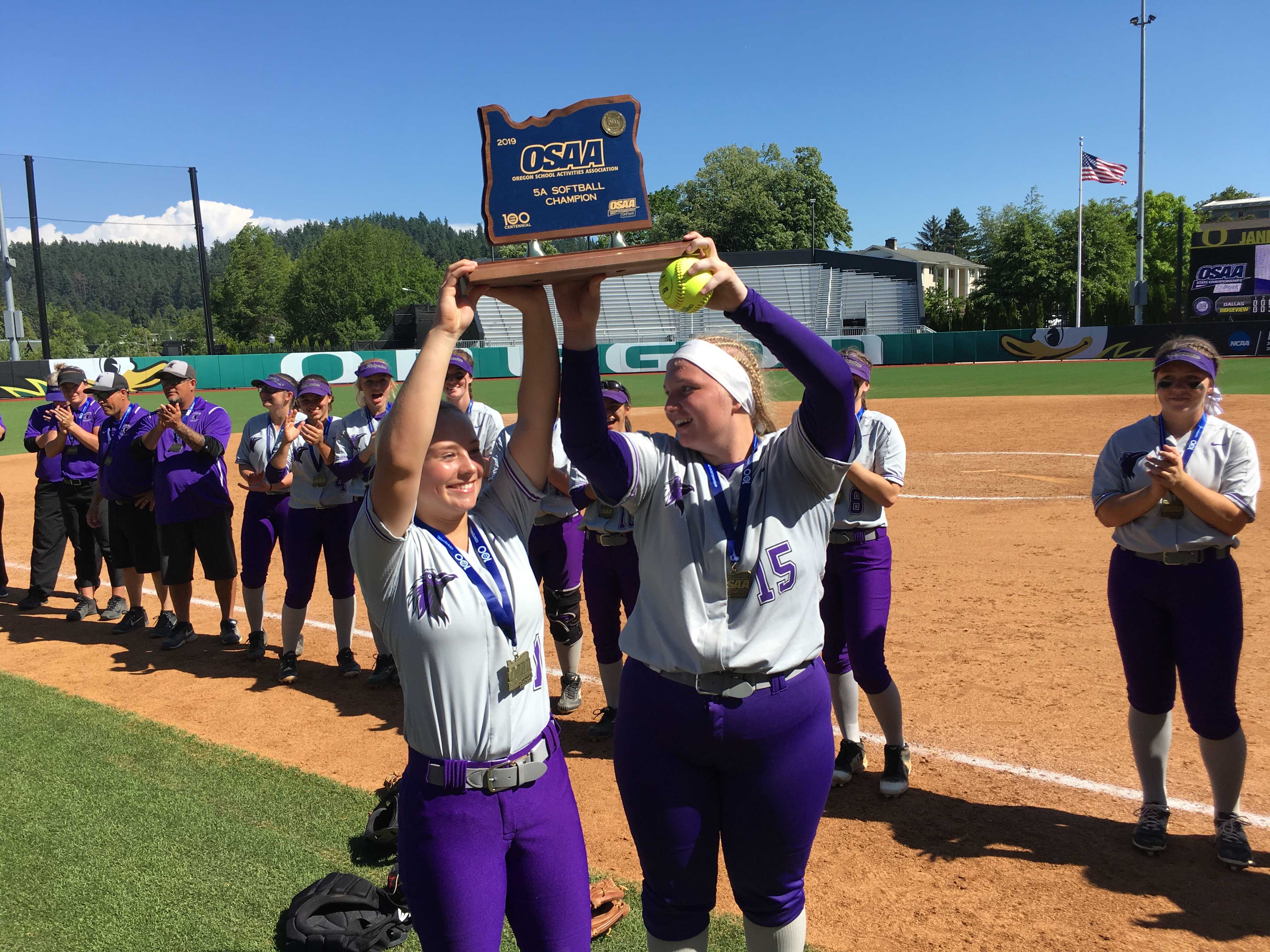Sage McVay (left) and Allicitie Frost hoist Ridgeview's first state championship trophy.