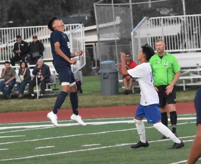 Stayton's Santos Navarro (left) goes after a header in Thursday's win over Woodburn. (Photo by Jeremy McDonald)