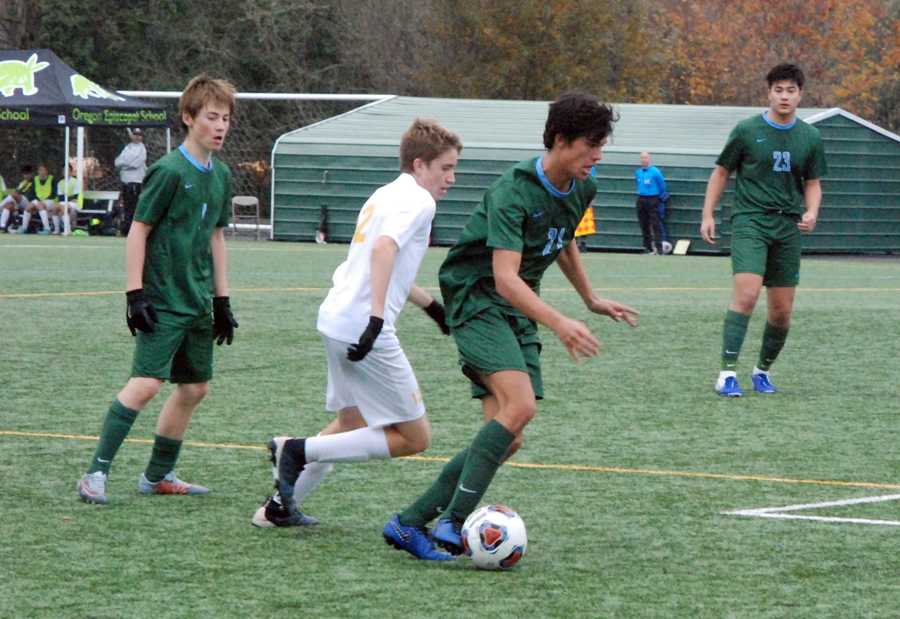 Alex Ugas (21) possesses the ball for OES against the challenge of Dylan Hodge. Patrick Ruoff (1) and Jonah Song look on