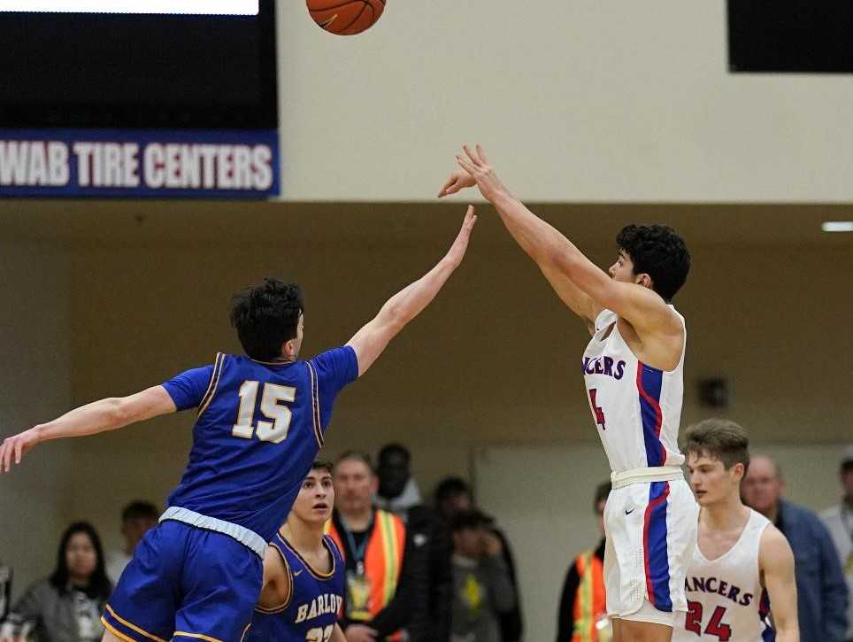 Churchill's Silas Bennion connects on the game-winning three-pointer over Barlow's Jesse White on Thursday. (Photo by Jon Olson)