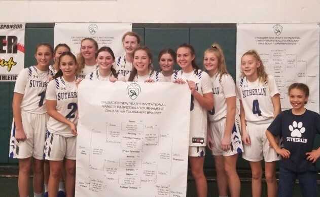 Sutherlin poses with the tournament bracket after winning the Crusader Classic New Year's Invitational.