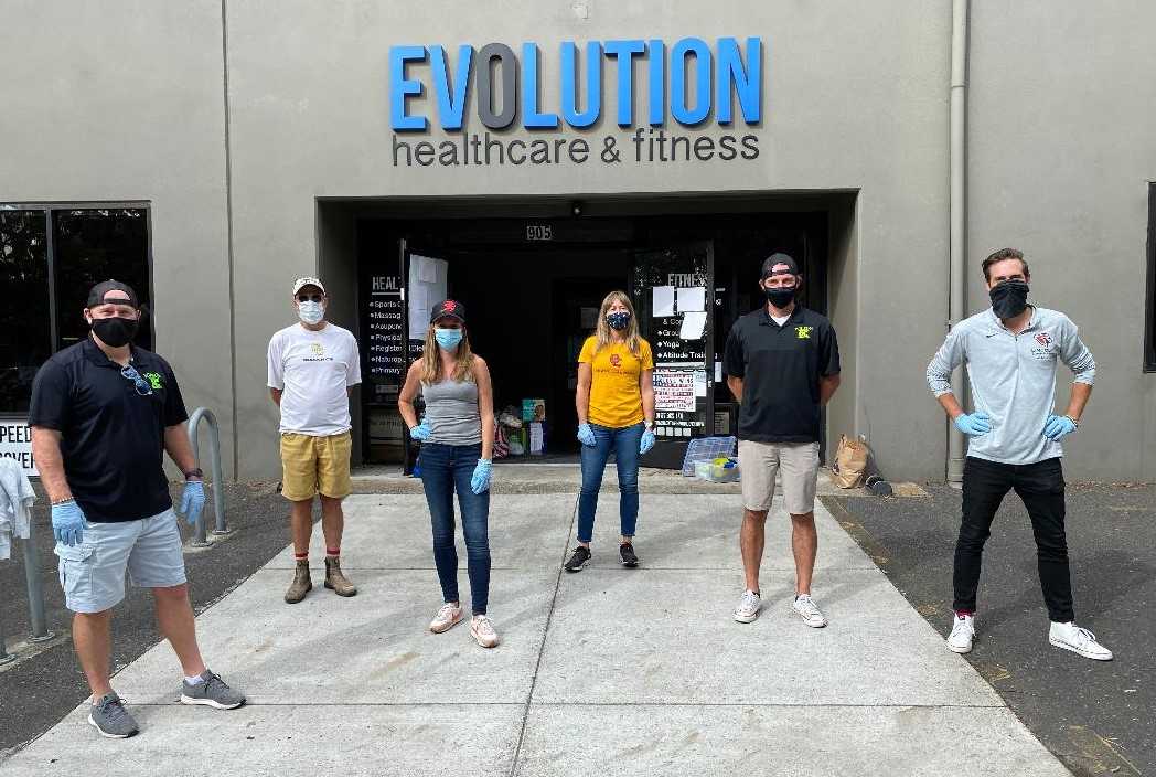 Coaches met to accept community donations at Evolution Fitness.