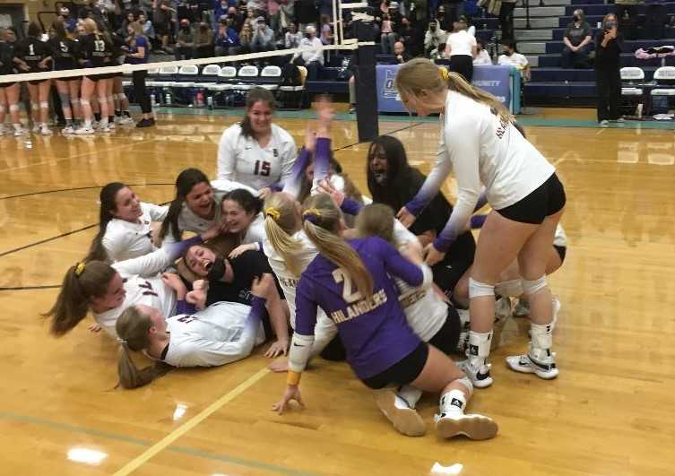 Burns players celebrate after wrapping up a four-set win over Sutherlin in the 3A volleyball final Saturday night.