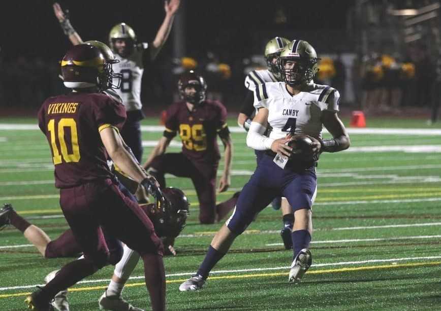 Canby quarterback Mikey Gibson ran and passed for touchdowns in a playoff win over Lebanon last week. (Photo by Lisa N Gibson)
