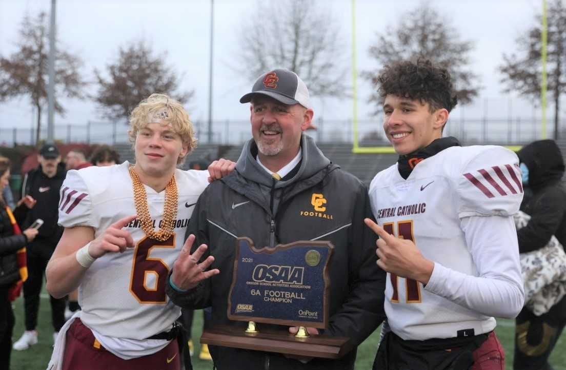 Central Catholic coach Steve Pyne celebrates his fourth title with Cru Newman (6) and Emerson Dennis (11). (Photo by Jim Nagae)