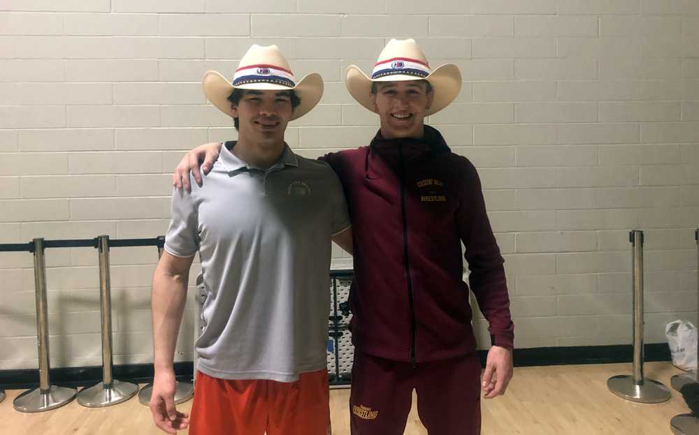 Justin Rademacher, left, and Daschle Lamer are all smiles after donning the coveted cowboy hats that signify victory at Doc B