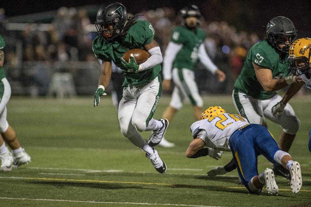 Tigard's Malcolm Stockdale dodges Barlow defenders Friday night. (Photo by Ralph Greene)