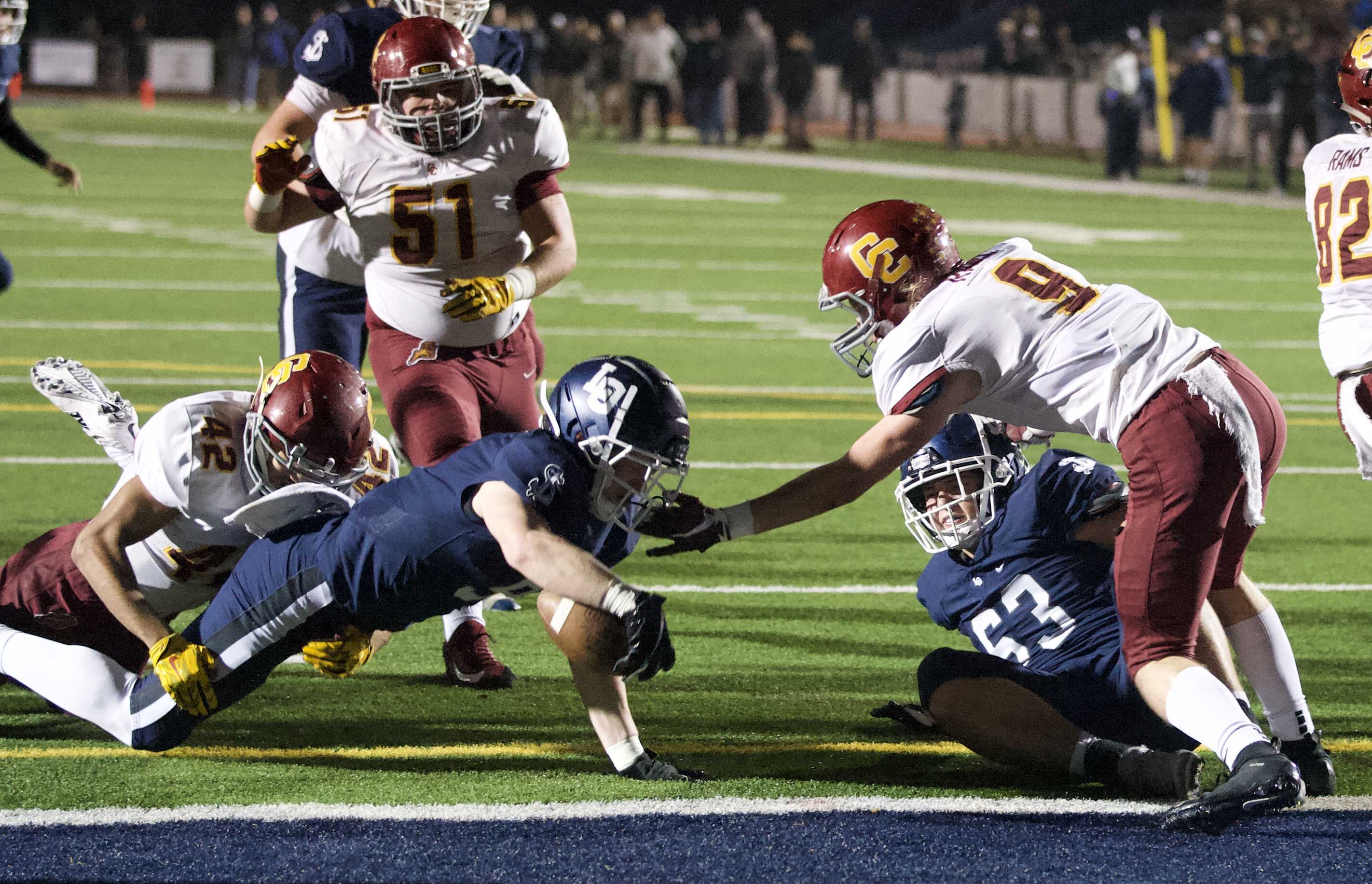 Casey Filkins scores the first of his three touchdowns in Lake Oswego's win Friday. (Photo by Norm Maves Jr.)