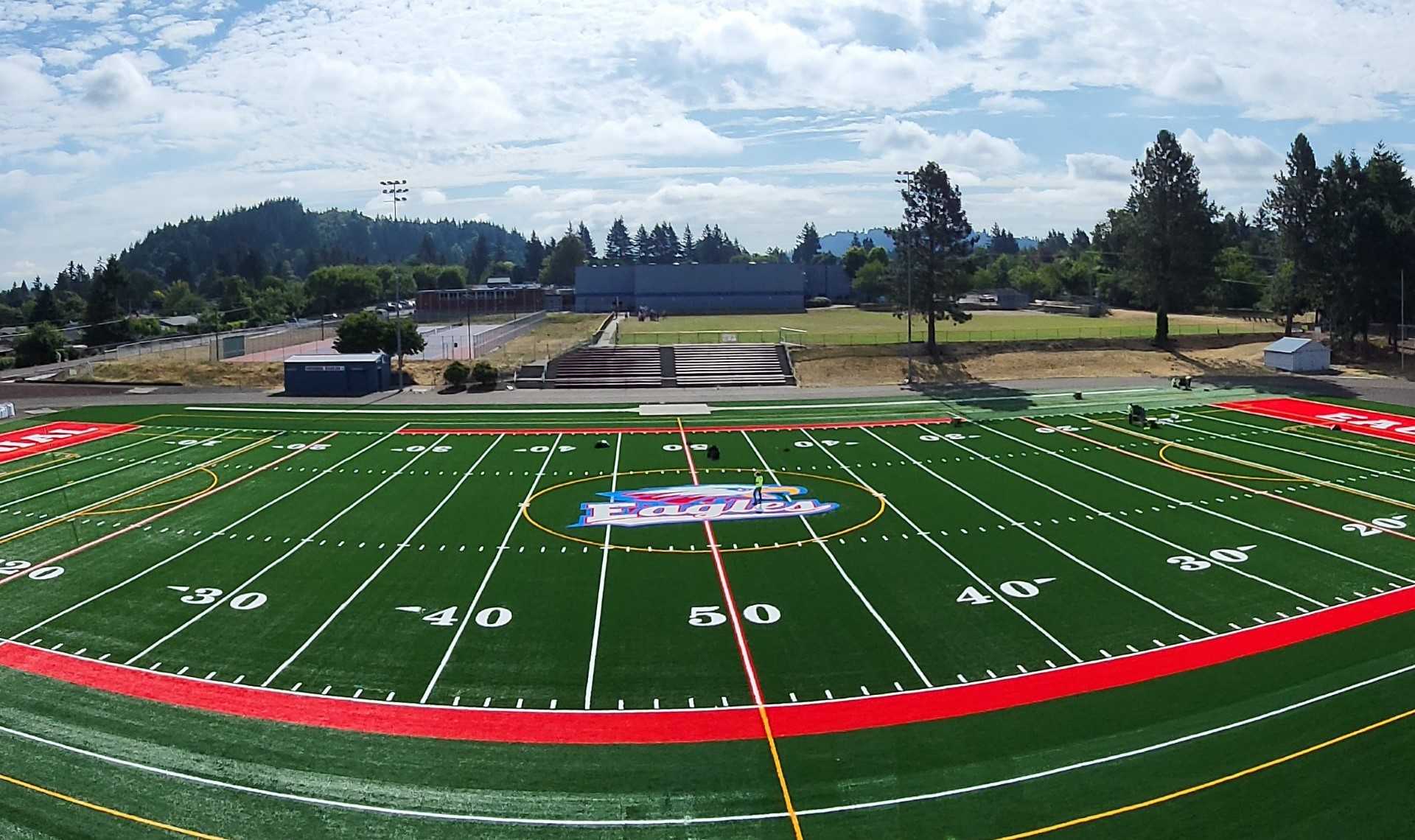Workers removed about 9,000 yards of dirt to level a 36-inch crown before Centennial's artificial turf was installed.