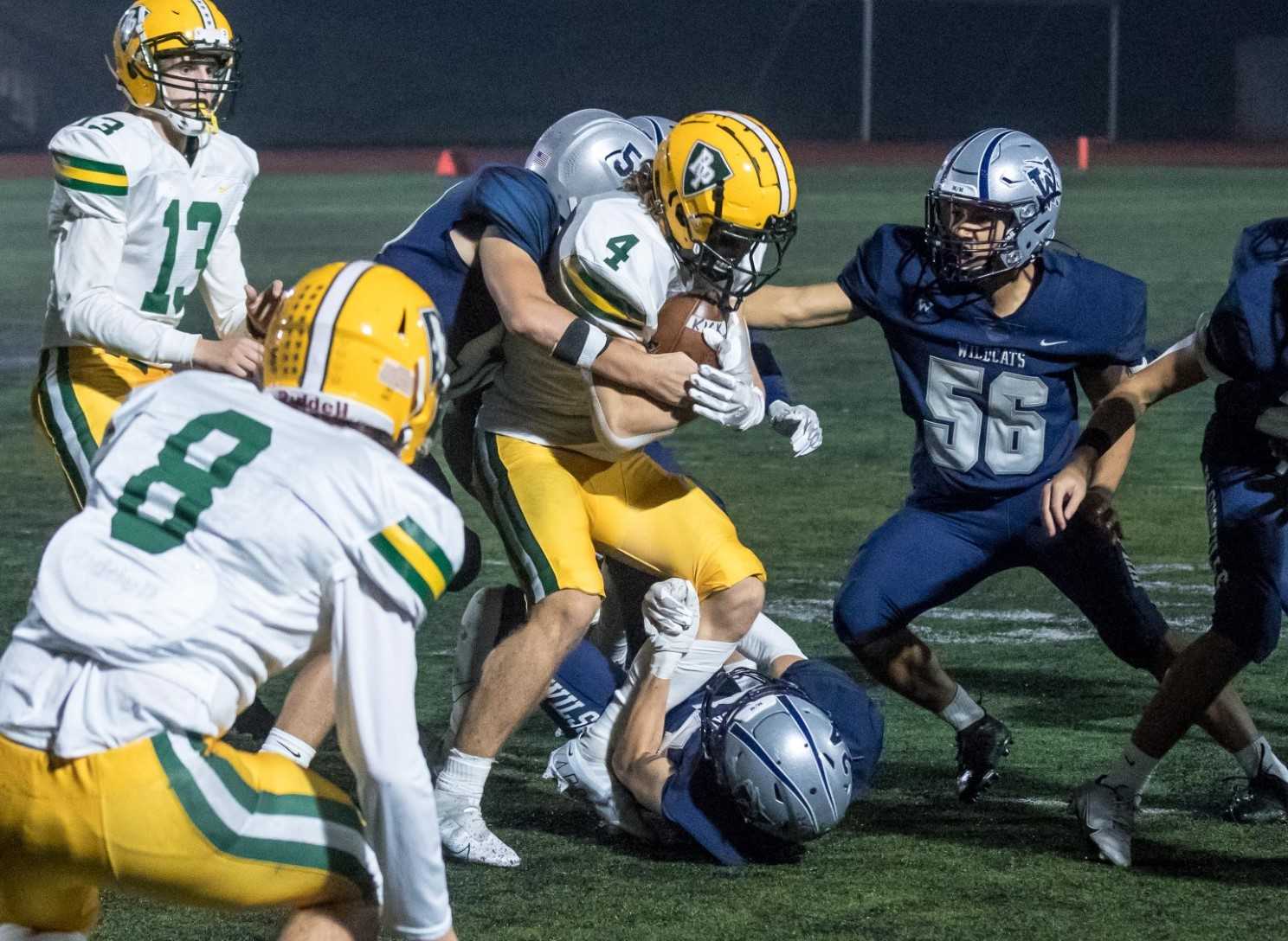 Putnam's Tyler Creswick (4) fights for yards in a 5A NWOC game at Wilsonville last season. (Photo by Greg Artman)