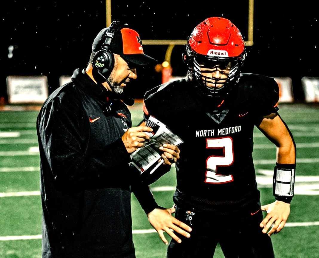 North Medford coach Nathan Chin has opened up the offense with quarterback Traeger Healy (2). (Photo by Captured 541)