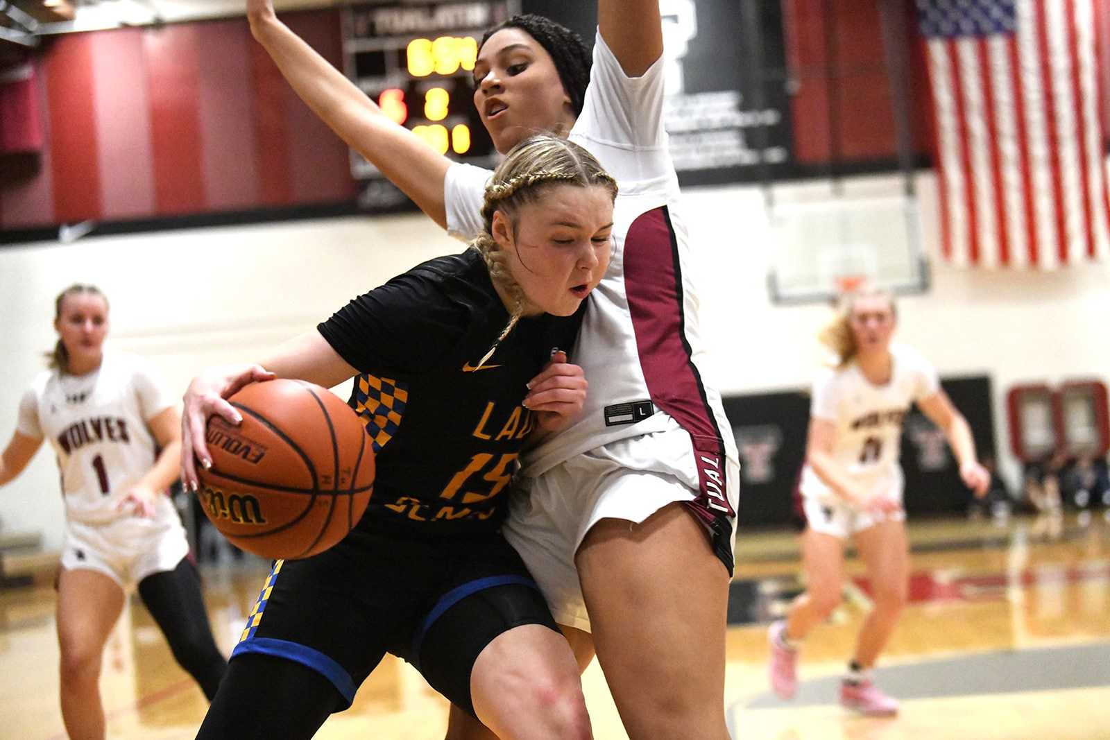 Jefferson's Chauncy Anderson drives against Tualatin's Jordyn Smith in Tuesday's nonleague game. (Photo by Fanta Mithmeuangneua)