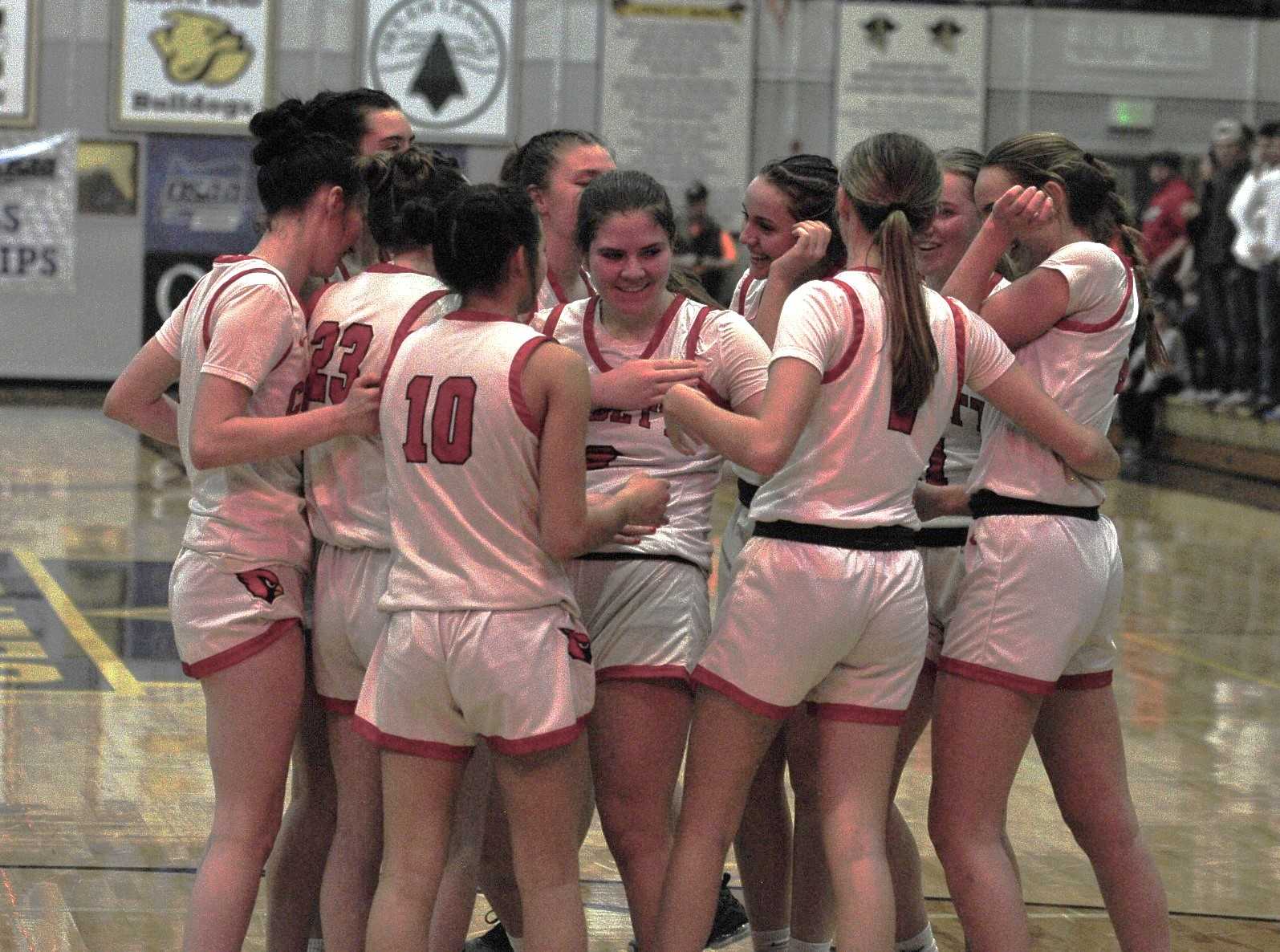 Corbett players celebrate around Carly Hardie after her late free throw lifted the Cardinals over Vale. (Photo by John Gunther)