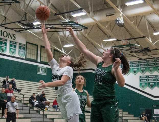 Tigard's Campbell Gray goes up for a shot against Sheldon's Emma Neuman (34). (Photo by Ralph Greene)