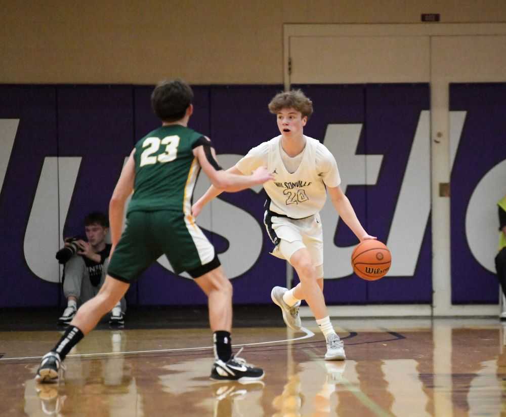 Jacob Boss, in white, works his way upcourt for Wilsonville against Lennon Greenleaf. (Photo by Fanta Mithmeuangnueua)