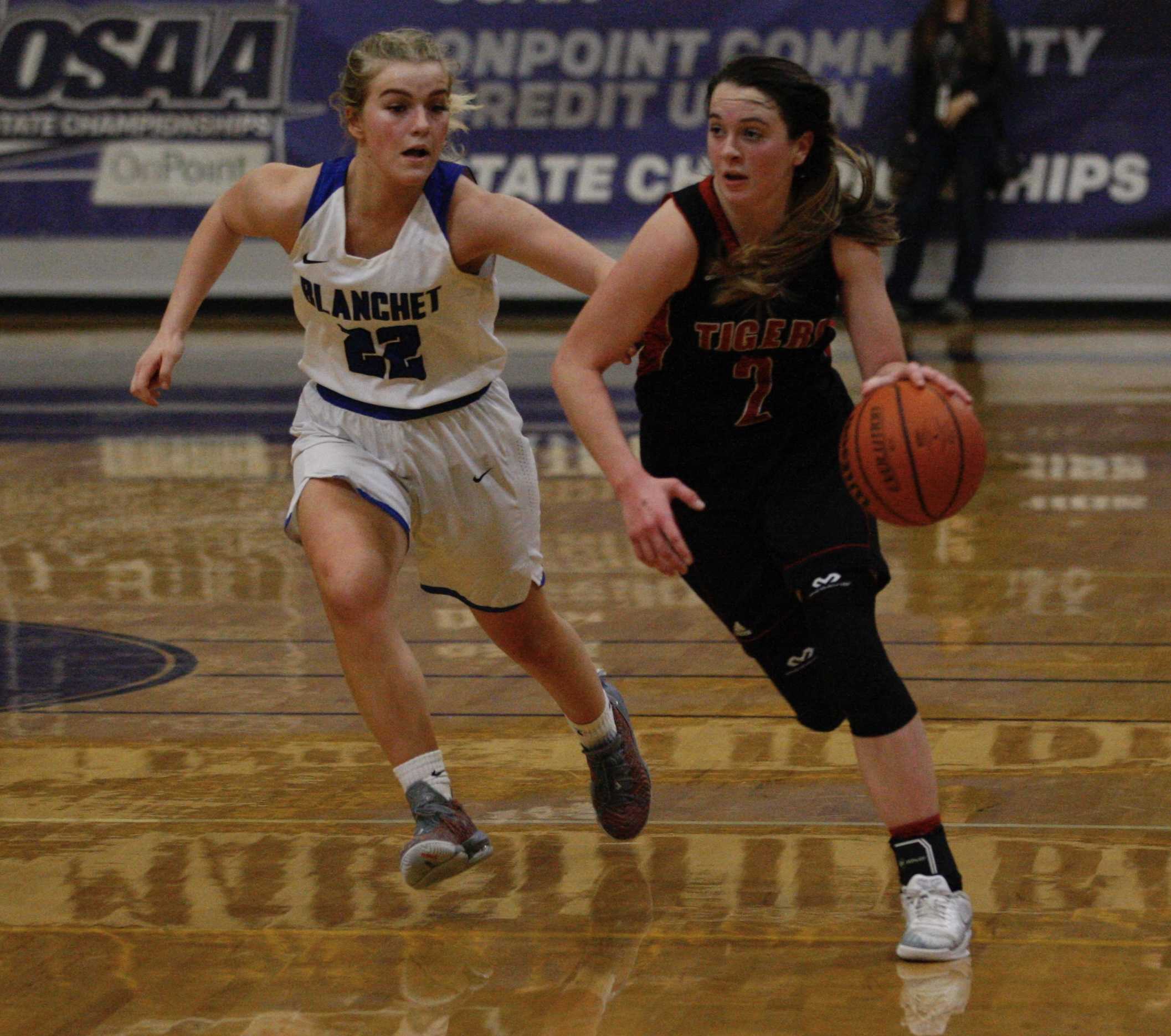 Clatskanie point guard Olivia Sprague barrels past Blanchet Catholic defender Bailey Hittner on her way to two of her 14 points