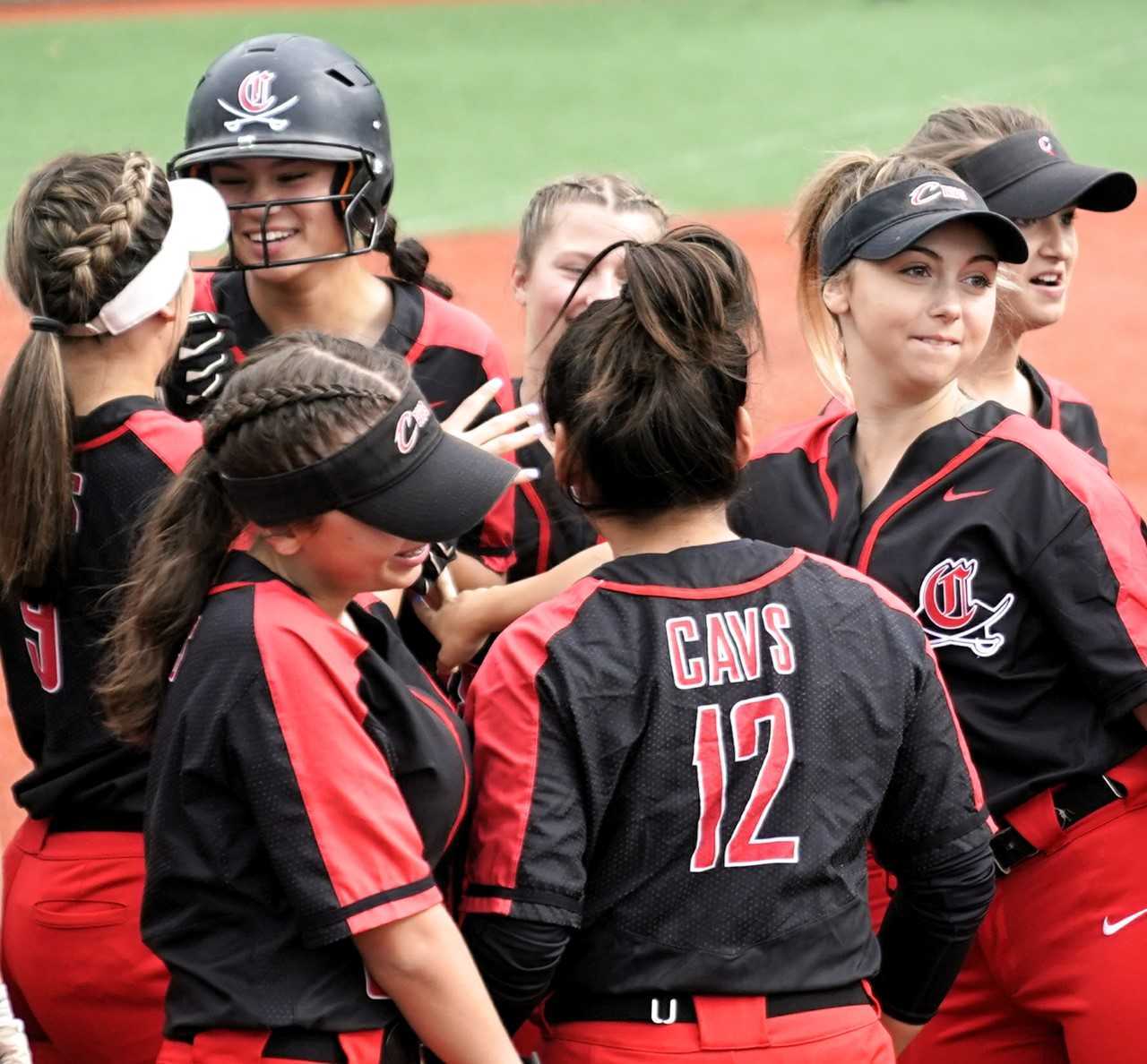 Clackamas players celebrate with Alyssa Daniell (helmet) after one of her two home runs. (Photo by Jon Olson)