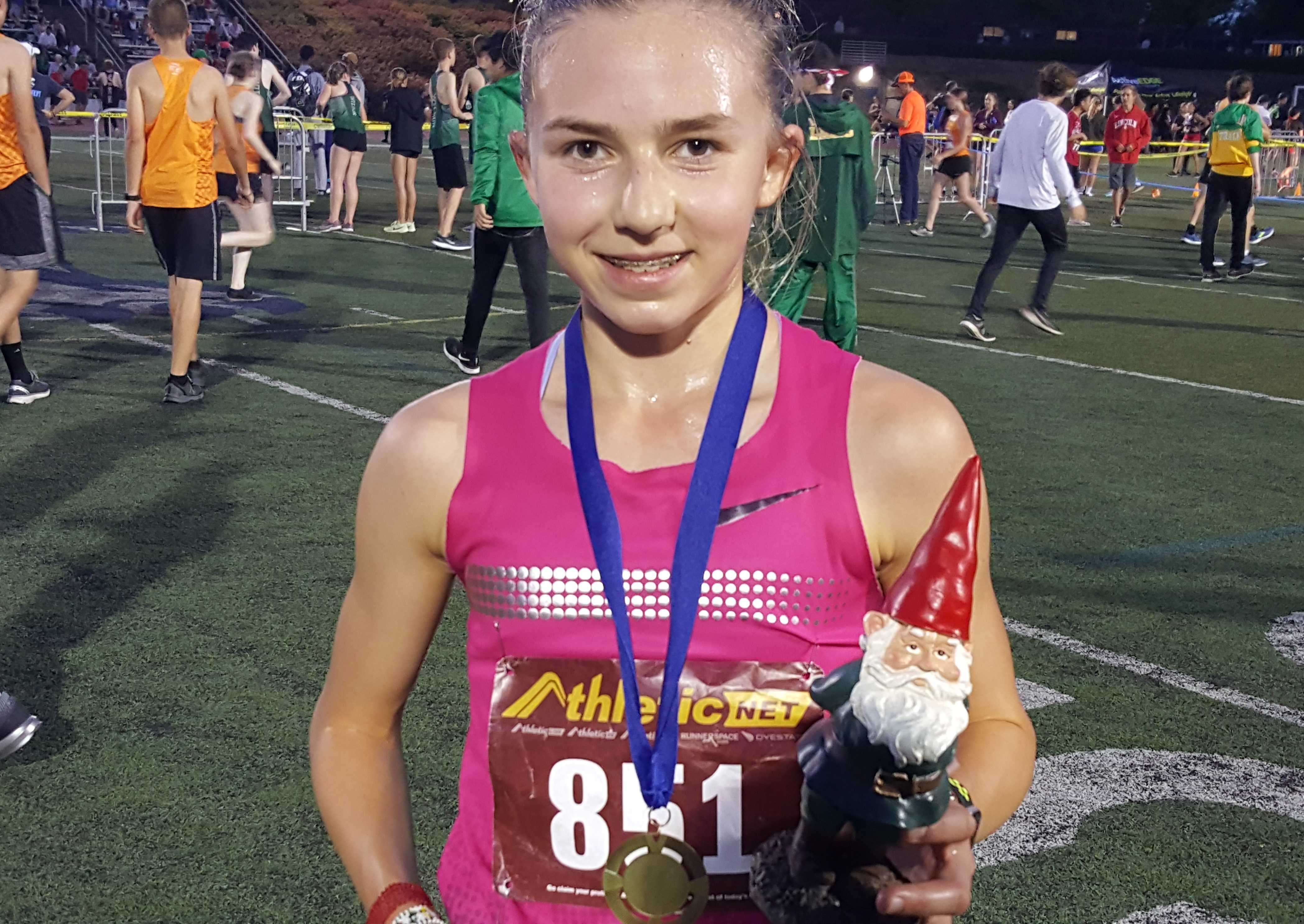 Kate Peters poses with her first-place garden gnome trophy at the Wilsonville Night Meet. (Photo by Doug Binder)